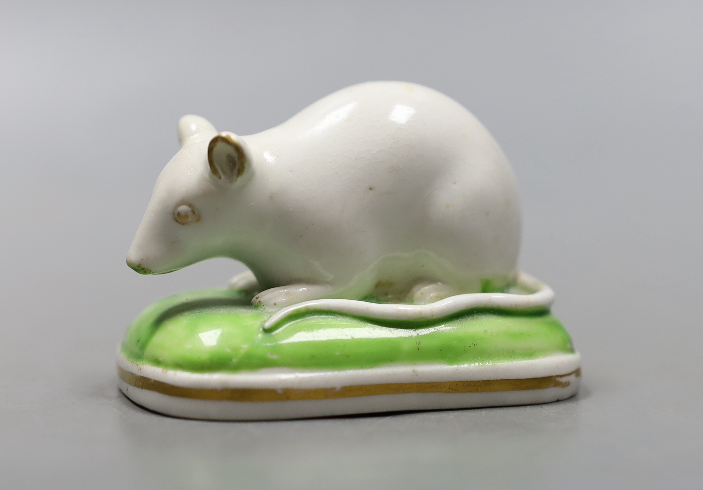 A Derby porcelain figure of a recumbent white mouse, c.1825-35, unmarked, 6.5cm, cf. D. G. Rice, English Porcelain Animals of the 19th century, colour plate 28b., Provenance- Dennis G Rice collection